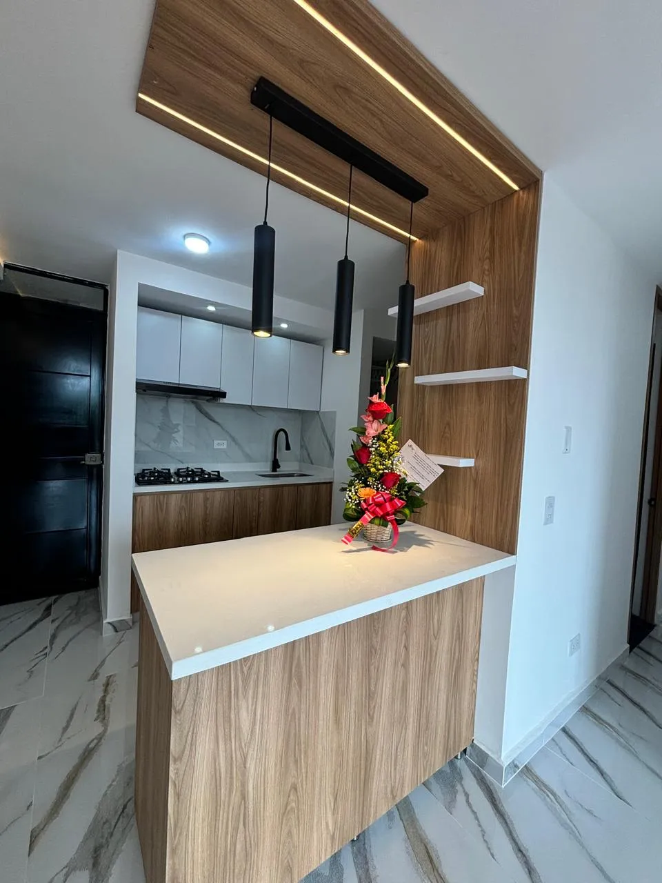 Cocina integral con isla y acabados de madera y mármol — proyecto de JMP Diseños y Acabados en Melgar, Tolima